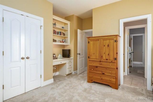 bedroom with a closet and light colored carpet