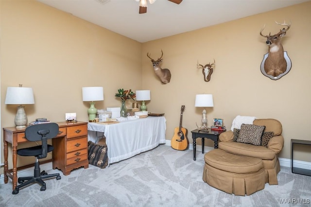 home office featuring ceiling fan and light carpet