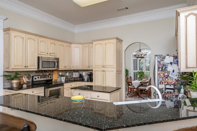 kitchen featuring kitchen peninsula, stainless steel appliances, tasteful backsplash, and dark stone countertops