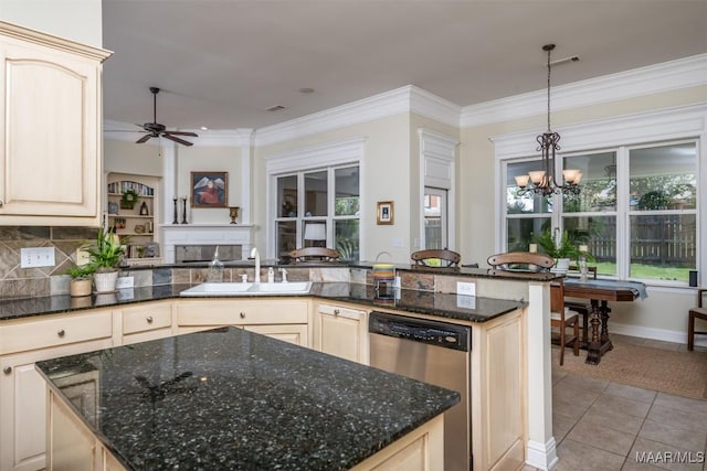 kitchen with sink, hanging light fixtures, stainless steel dishwasher, light tile patterned flooring, and ceiling fan with notable chandelier