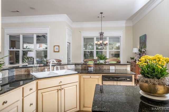 kitchen featuring stainless steel dishwasher, sink, dark stone countertops, a chandelier, and hanging light fixtures