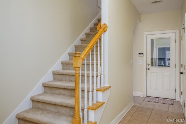 stairs featuring tile patterned floors