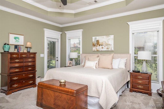 carpeted bedroom with ceiling fan, a raised ceiling, ornamental molding, and access to outside