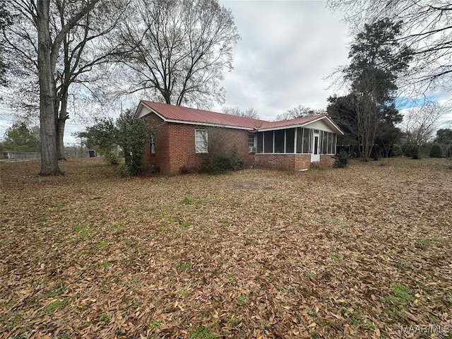 view of home's exterior featuring a sunroom