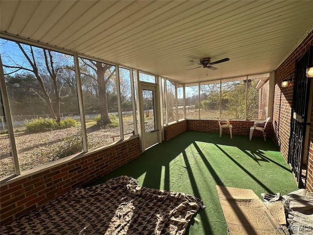 unfurnished sunroom with ceiling fan