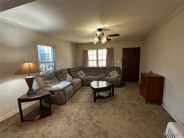 carpeted living room with crown molding and ceiling fan