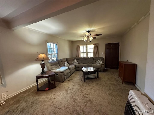 carpeted living room with heating unit, crown molding, and ceiling fan