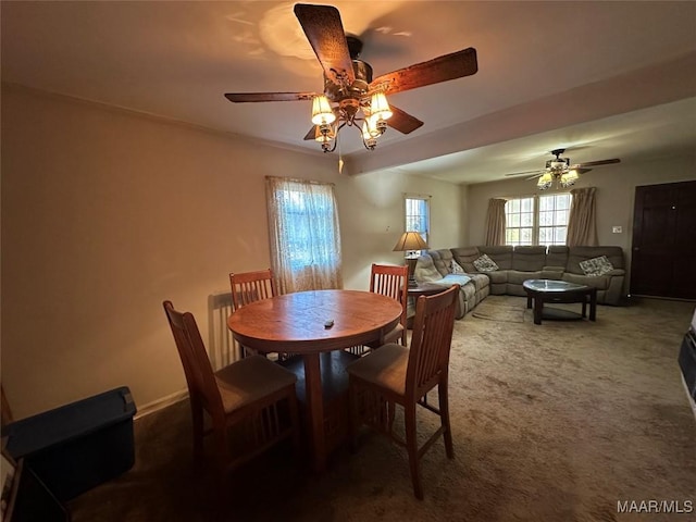 carpeted dining space with ceiling fan