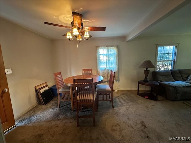 carpeted dining area with beamed ceiling and ceiling fan