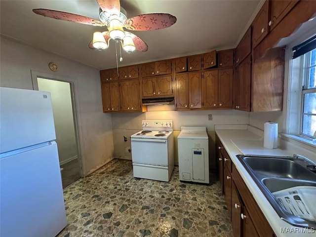 kitchen with washer and clothes dryer, ceiling fan, white appliances, and sink