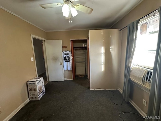 unfurnished bedroom featuring dark colored carpet, cooling unit, crown molding, ceiling fan, and a closet