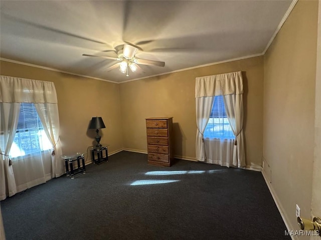 interior space featuring dark carpet, a wealth of natural light, crown molding, and ceiling fan