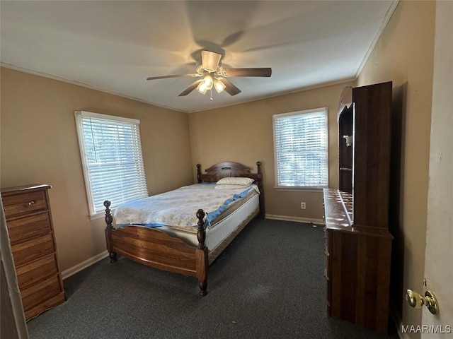 bedroom featuring ceiling fan, crown molding, and dark colored carpet