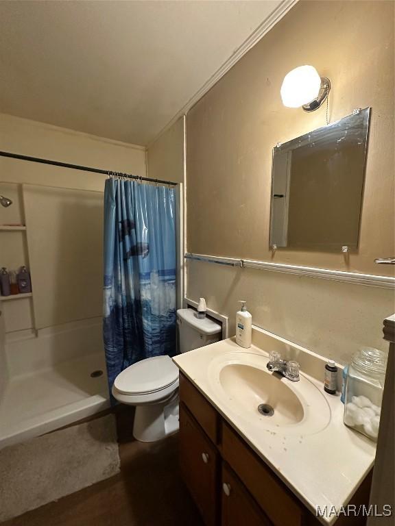 bathroom with curtained shower, crown molding, hardwood / wood-style floors, toilet, and vanity