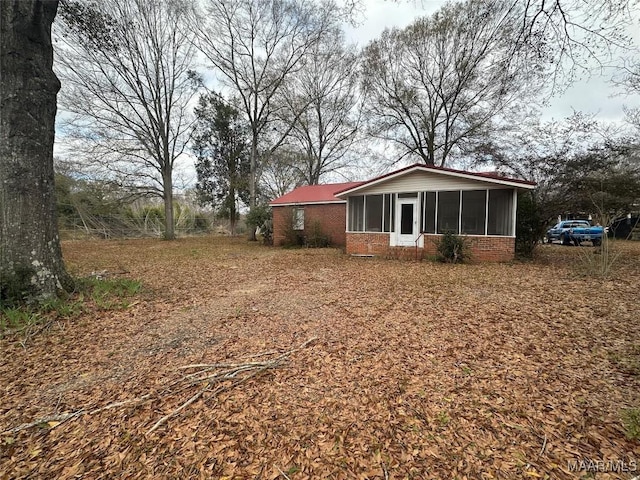 view of side of home featuring a sunroom