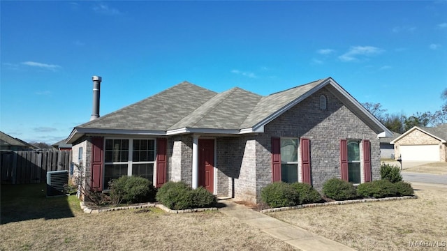 view of front of house with central AC and a front lawn