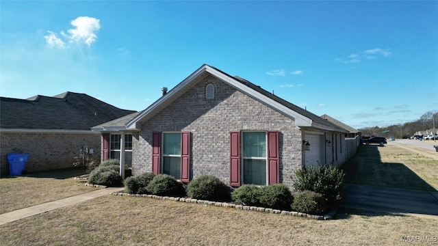 view of front of house featuring a garage and a front lawn