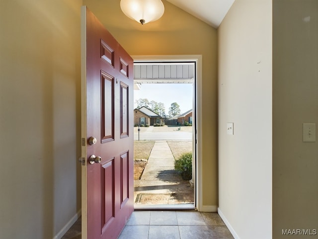 tiled foyer with vaulted ceiling