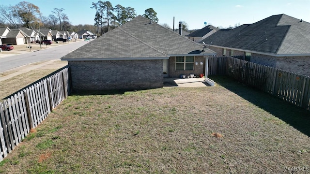 rear view of property featuring a lawn