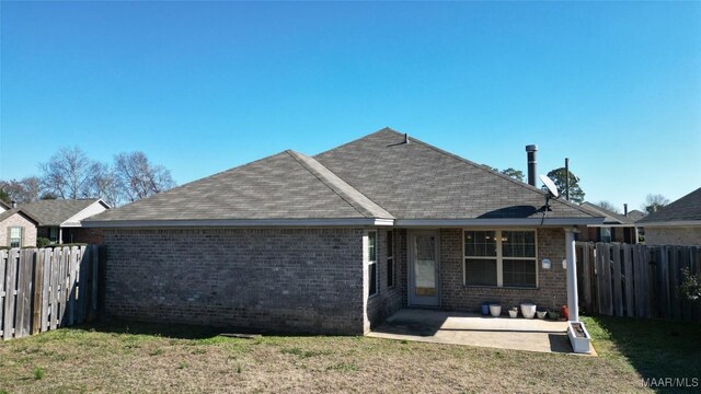 back of house featuring a yard and a patio area