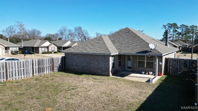 back of house with a yard and a patio area