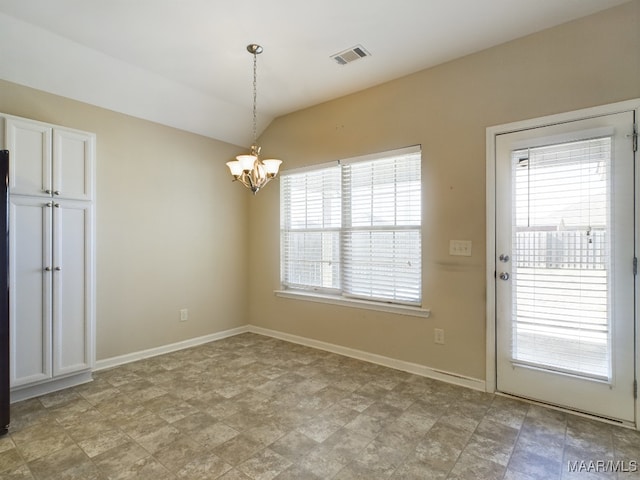 unfurnished dining area with lofted ceiling and a chandelier