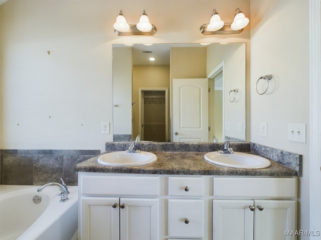 bathroom with a washtub and vanity