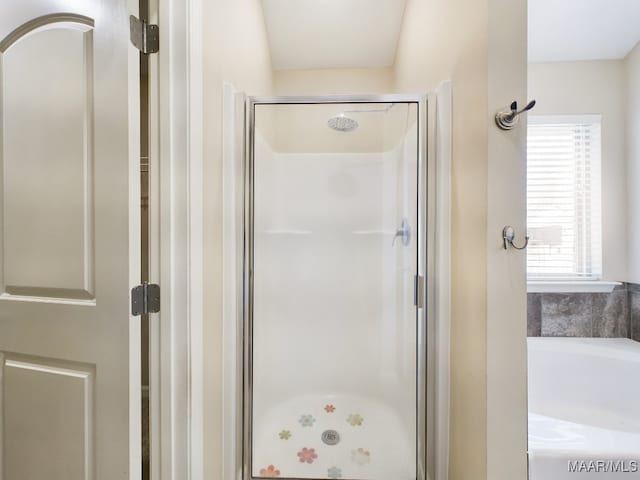 bathroom featuring walk in shower and a wealth of natural light