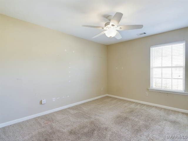 empty room with light colored carpet and ceiling fan