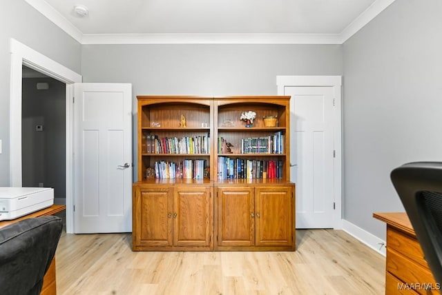 home office with crown molding and light hardwood / wood-style flooring