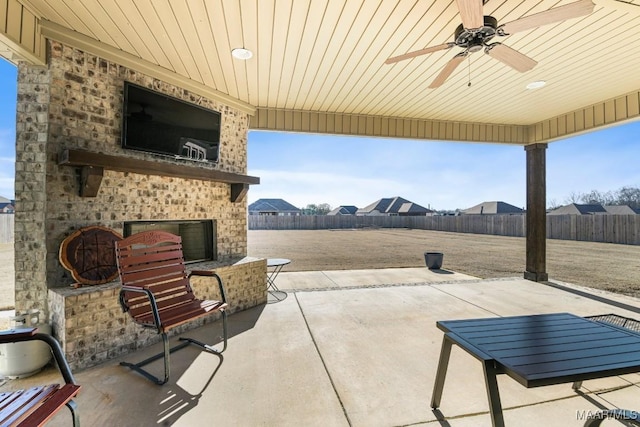 view of patio / terrace with an outdoor brick fireplace and ceiling fan