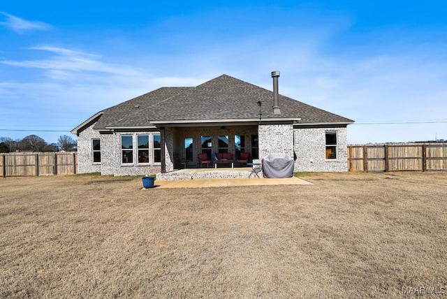 back of property featuring a yard and a patio