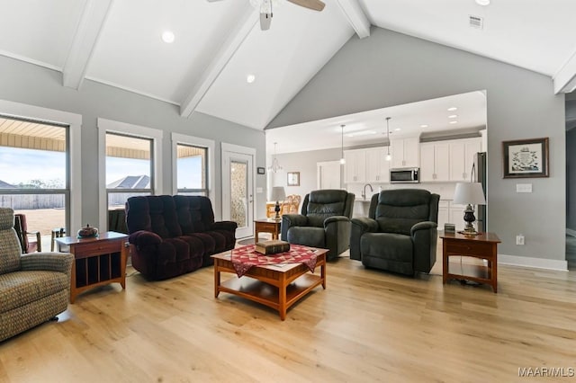 living room with beam ceiling, ceiling fan, high vaulted ceiling, and light hardwood / wood-style floors