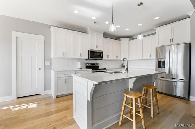 kitchen with sink, white cabinets, and stainless steel appliances