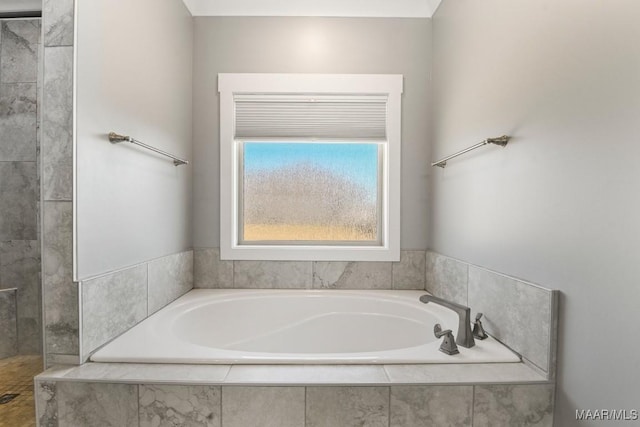 bathroom featuring tiled bath