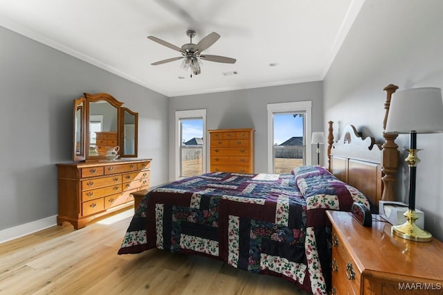 bedroom with light wood-type flooring, ceiling fan, and crown molding