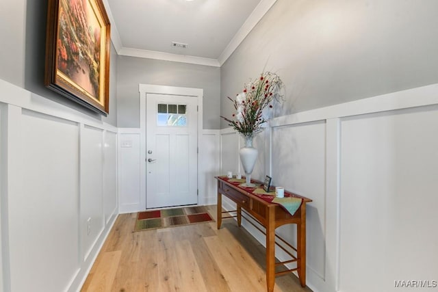 entryway featuring light hardwood / wood-style flooring and crown molding