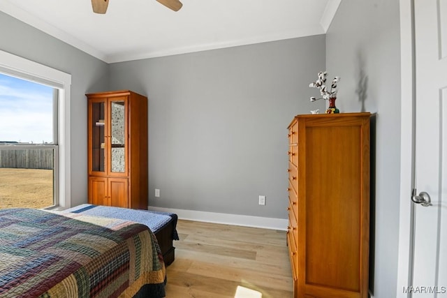 bedroom with light hardwood / wood-style floors, ceiling fan, and crown molding