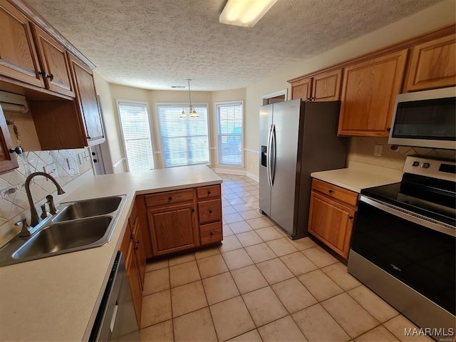 kitchen featuring an inviting chandelier, sink, appliances with stainless steel finishes, decorative light fixtures, and light tile patterned flooring