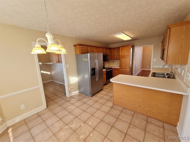 kitchen featuring black electric range oven, an inviting chandelier, sink, stainless steel refrigerator with ice dispenser, and decorative light fixtures