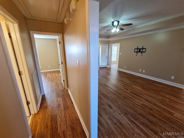 hallway featuring wood-type flooring and crown molding