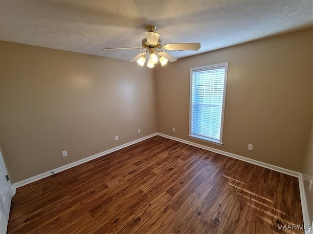 empty room with dark hardwood / wood-style floors, ceiling fan, and a textured ceiling