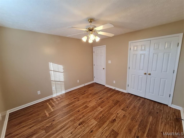 unfurnished bedroom featuring wood-type flooring and ceiling fan