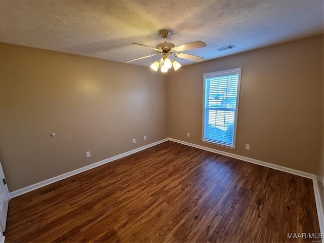 unfurnished room featuring a textured ceiling, ceiling fan, and dark wood-type flooring