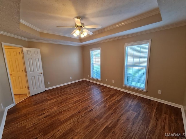 spare room with hardwood / wood-style floors, ceiling fan, a raised ceiling, and ornamental molding