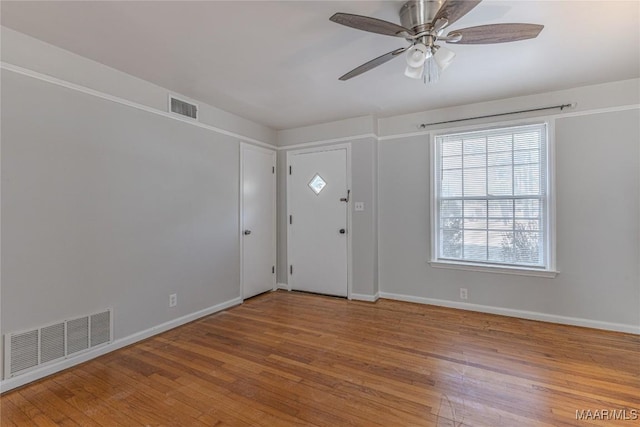 foyer entrance with hardwood / wood-style flooring and ceiling fan