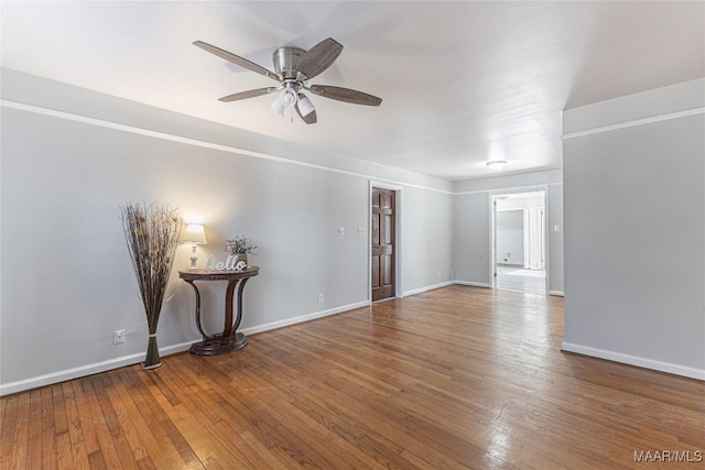 spare room with hardwood / wood-style flooring and ceiling fan