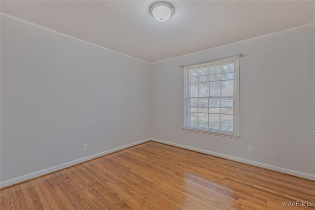 unfurnished room featuring crown molding and light hardwood / wood-style floors