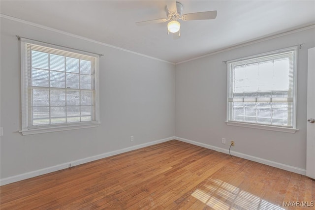 spare room featuring light wood-type flooring, ceiling fan, and crown molding