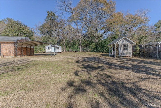 view of yard with a carport and a storage shed